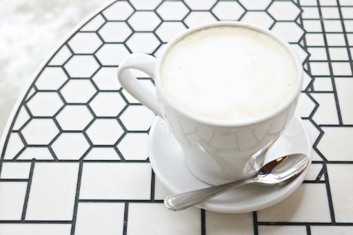 A cup of milk on a table; oat milk; beverage; drink; new year drink